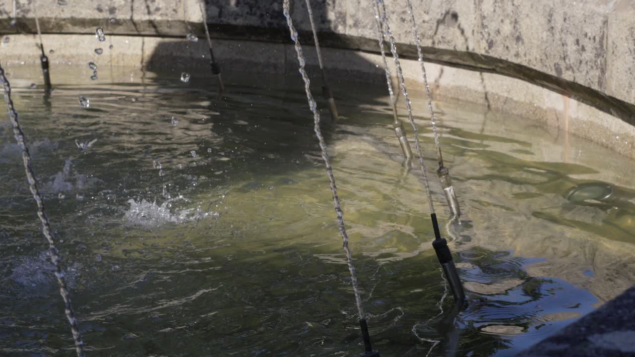 Water Jet In Stone Fountain Under The Shadow And Sunlight With Clear Water
