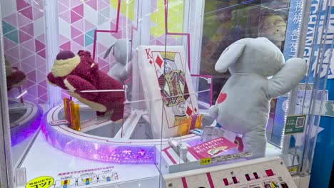 stuffed toy elephant tries to grab prize in claw machine