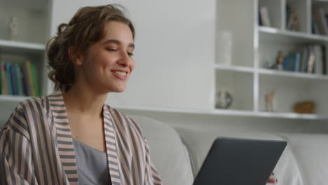 smiling student having video call in living room closeup. happy girl wave screen