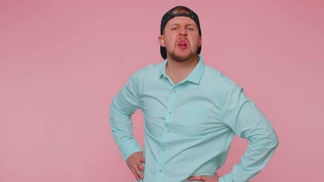 Funny man showing tongue making faces at camera fooling around joking aping with silly face