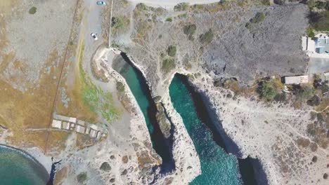 aerial drone bird's eye view of iconic lunar volcanic white chalk caves of papafragas, milos island, cyclades, greece