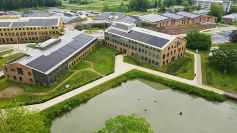 aerial view of a modern high school campus with solar panels on the rooftops of the buildings