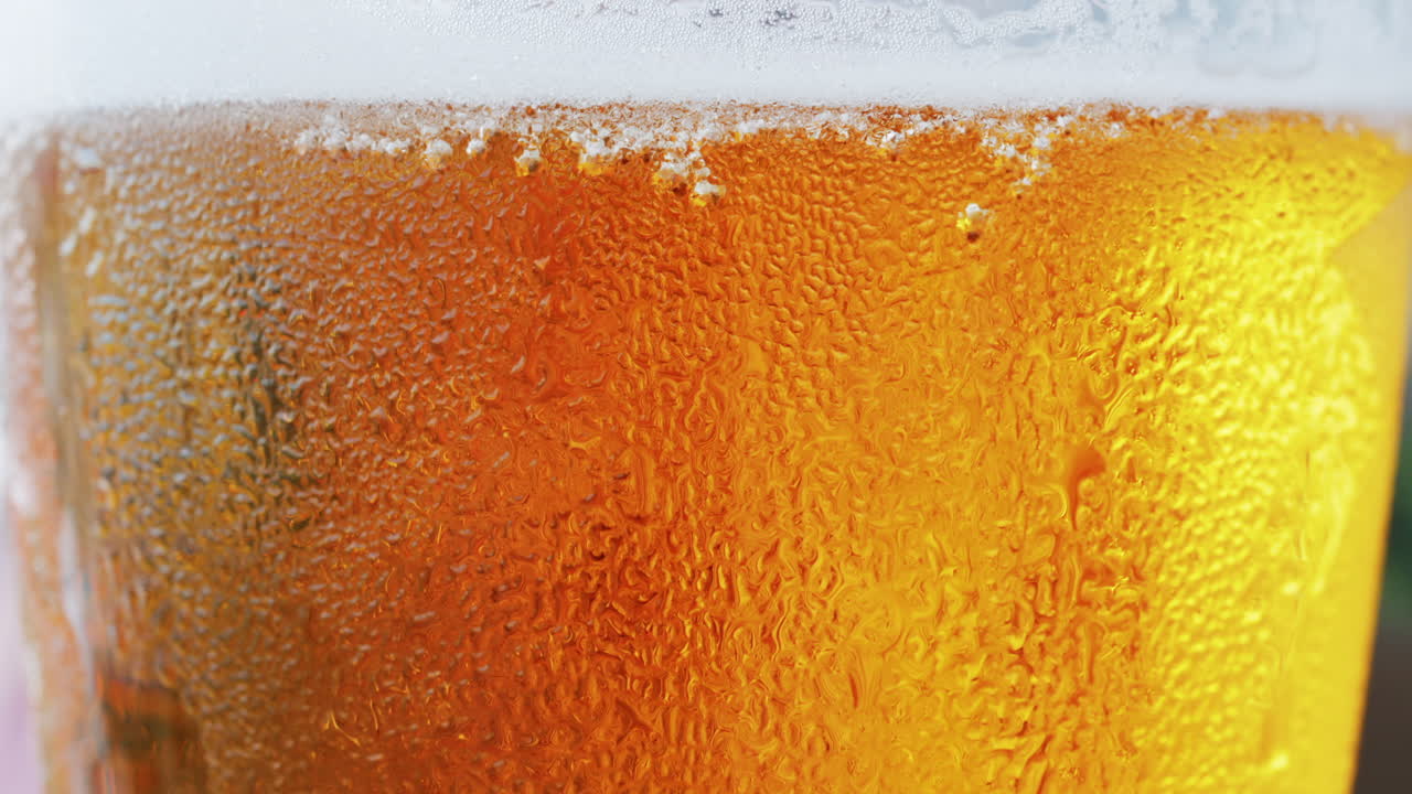 Close up of bubbles forming into foam in a beer glass