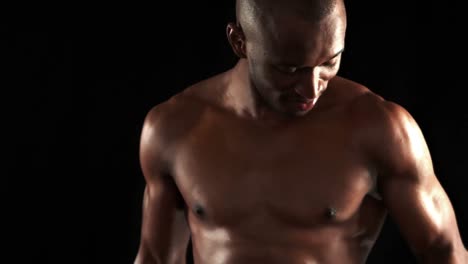 serious muscular man doing weightlifting