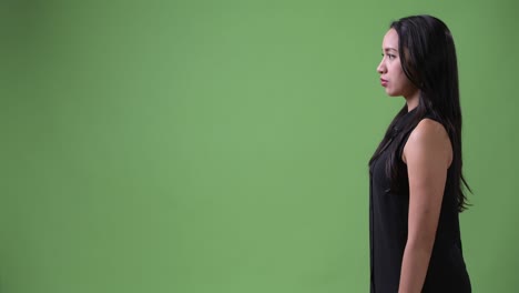 profile view of young beautiful asian businesswoman pointing finger
