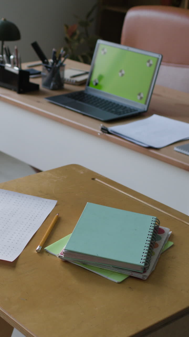 Home Office Workspace with Laptop and Notebooks