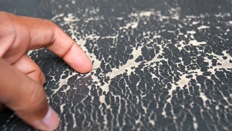 Hand Pointing to Cracked Leather