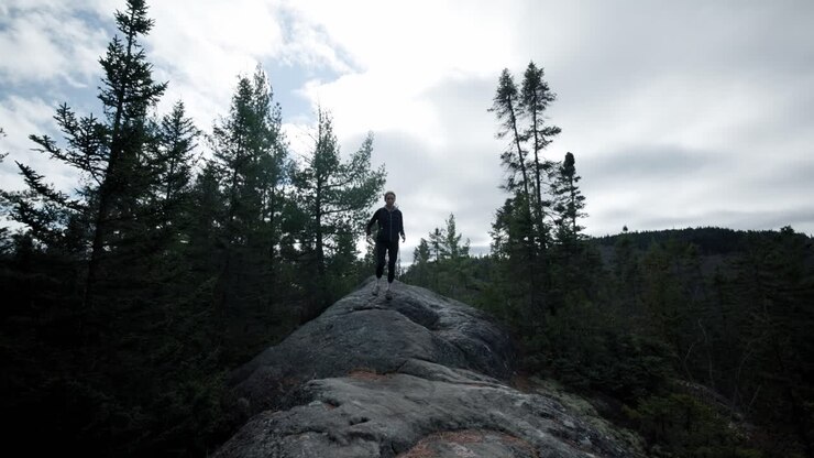 Caucasian Woman Hiker Running Down A Big Rock Nature Trail At Saint-Come, Quebec, Canada