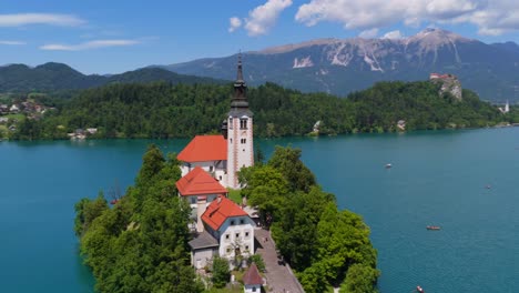 drone fly-in toward the iconic island church surrounded by crystal clear blue water