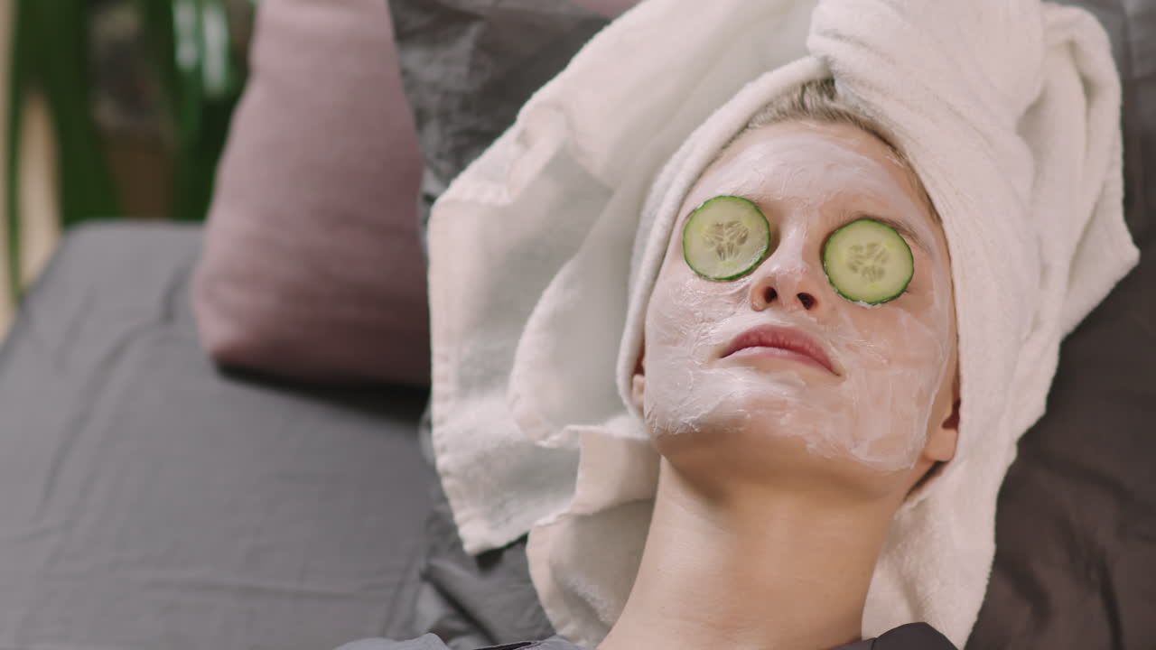 Girl In Facial Mask And Cucumber Slices On Mask