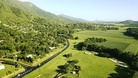 aerial view of motorway going through the hills and grassland