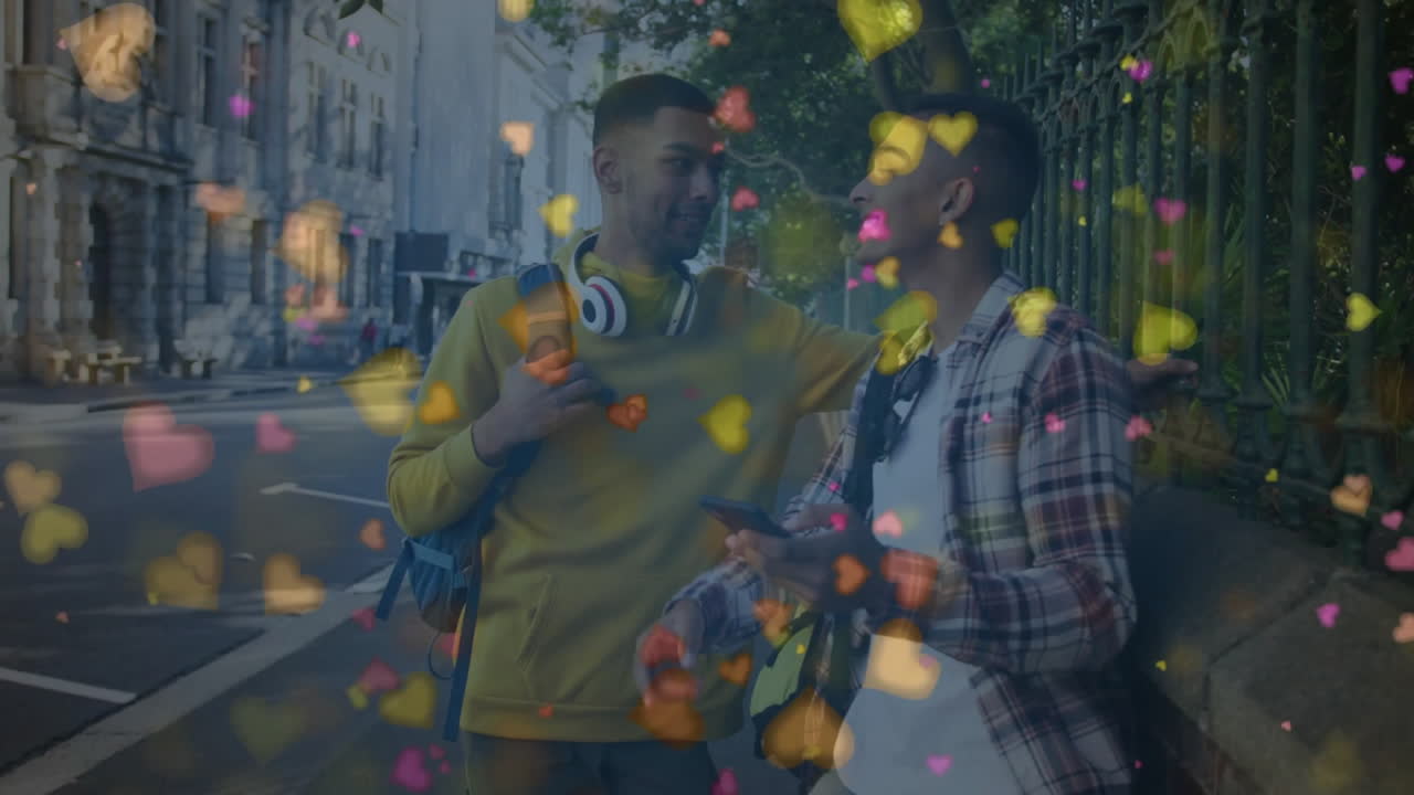Two men sharing smartphone on urban sidewalk, with animated hearts floating in technology marketing