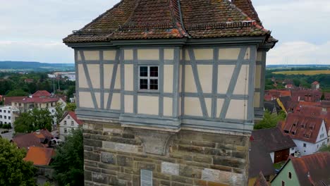 4k aerial drone video of the röderturm tower on the walled city of rothenburg, germany with the historic town hall and iconic gothic st