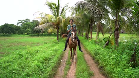 Young-handsome-man-with-brown-horse