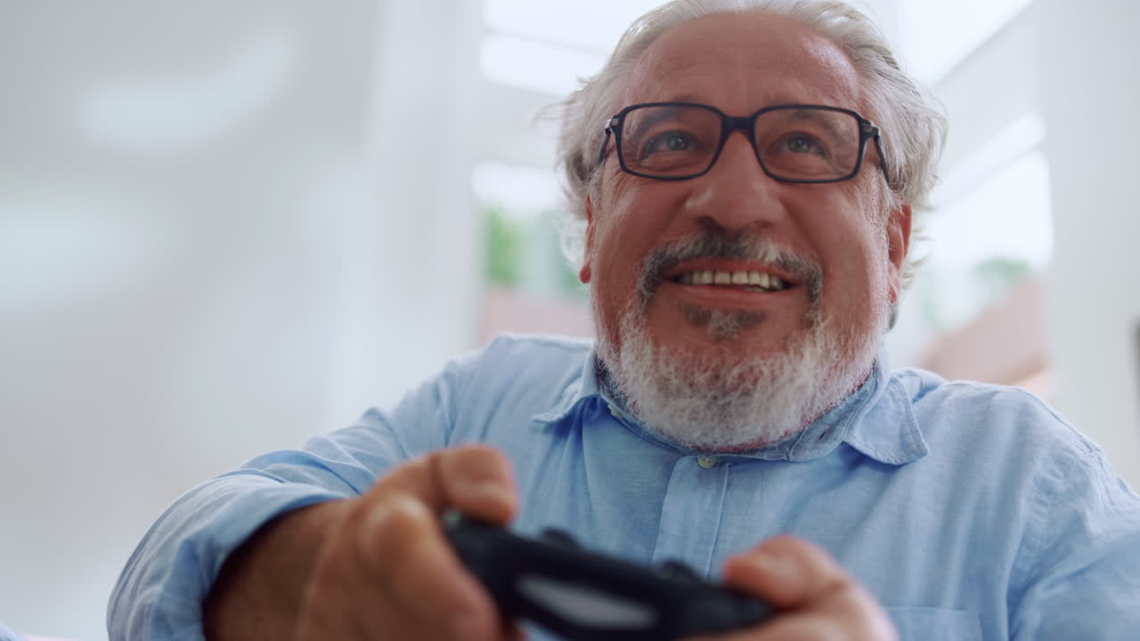 Portrait of smiling senior man playing video game
