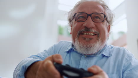 Portrait-of-smiling-senior-man-playing-video-game