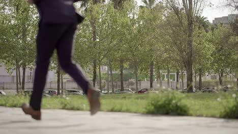 Low-section-of-businessman-running-on-stairs-outdoor