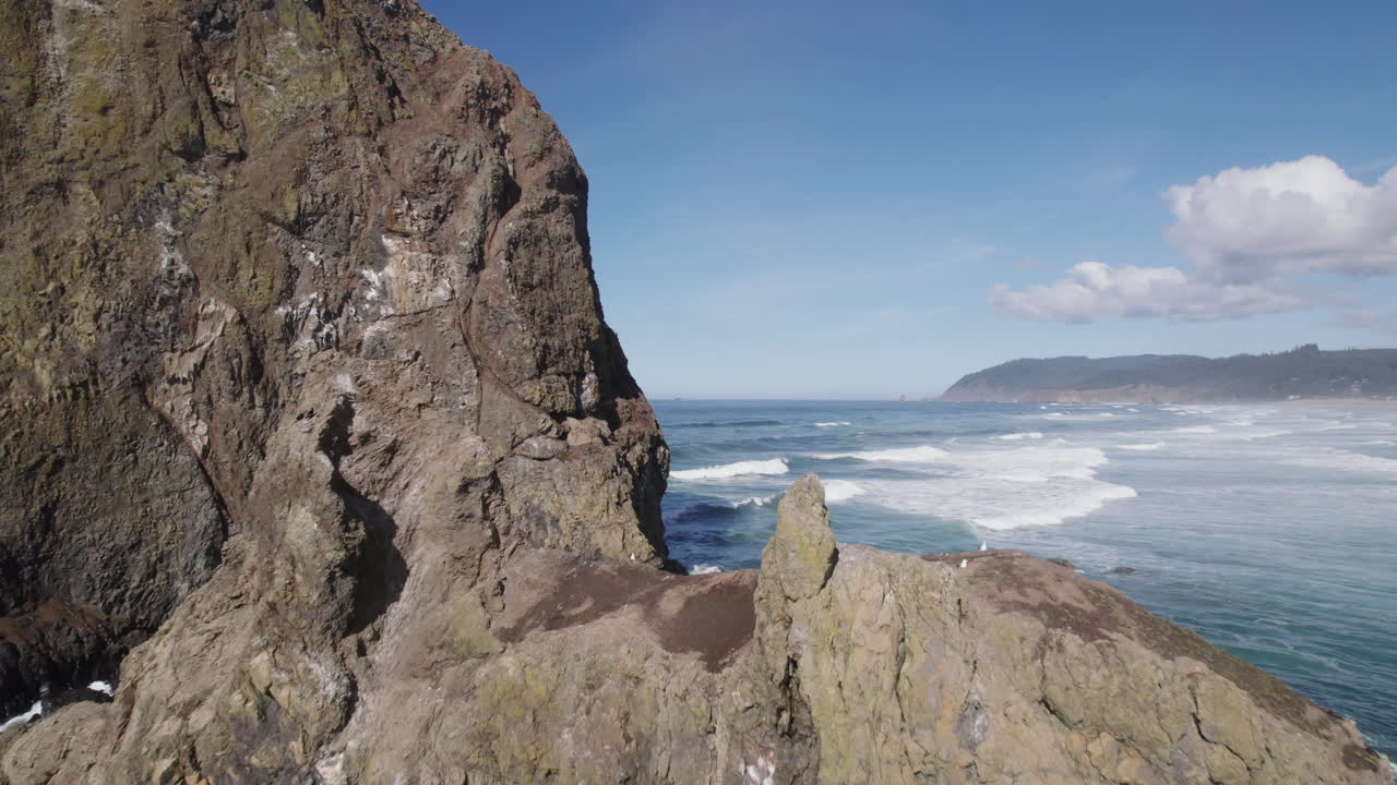 Close fly by of Haystack Rock at Cannon Beach