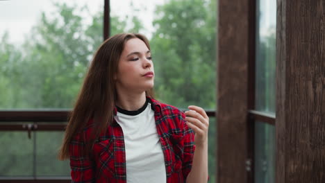 melancholic lady sweeps hair away from face woman solemn expression hints at depth of emotions