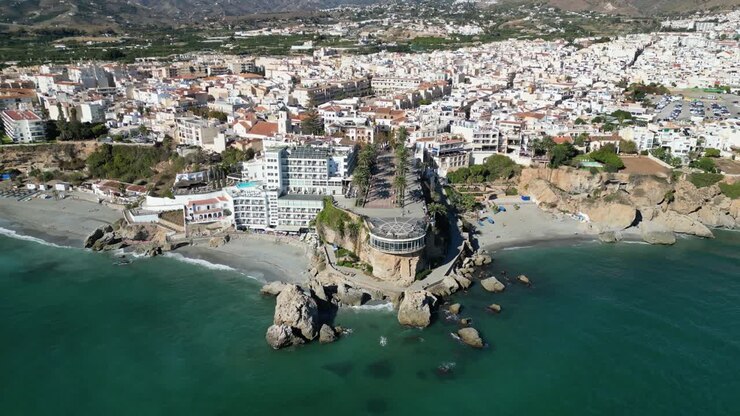 Nerja Coastal Village and Balcon de Europa in Malaga, Costa del Sol, Andalusia, Spain - Aerial 4k Birdseye Tilting Up