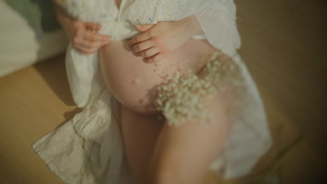 closeup of pregnant woman's belly in sensual portrait
