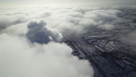industrial area covered in fog and clouds, aerial view in winter