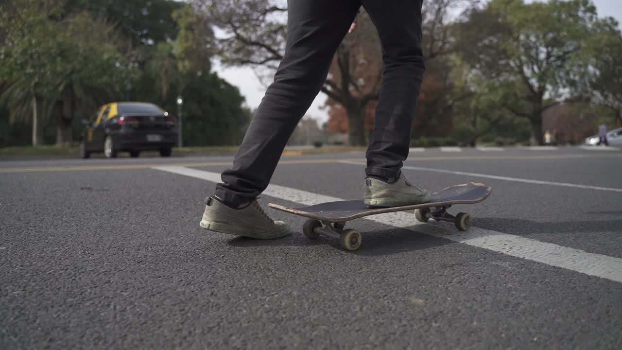 Close up skater riding on the street close to park