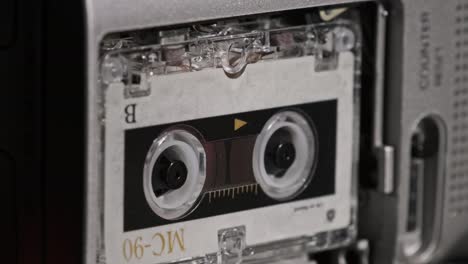 audio cassette in the tape recorder playing and rotates