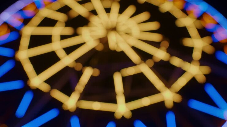 Blurred Ferris wheel with colourful lights at night