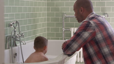 father and son having fun at bath time together