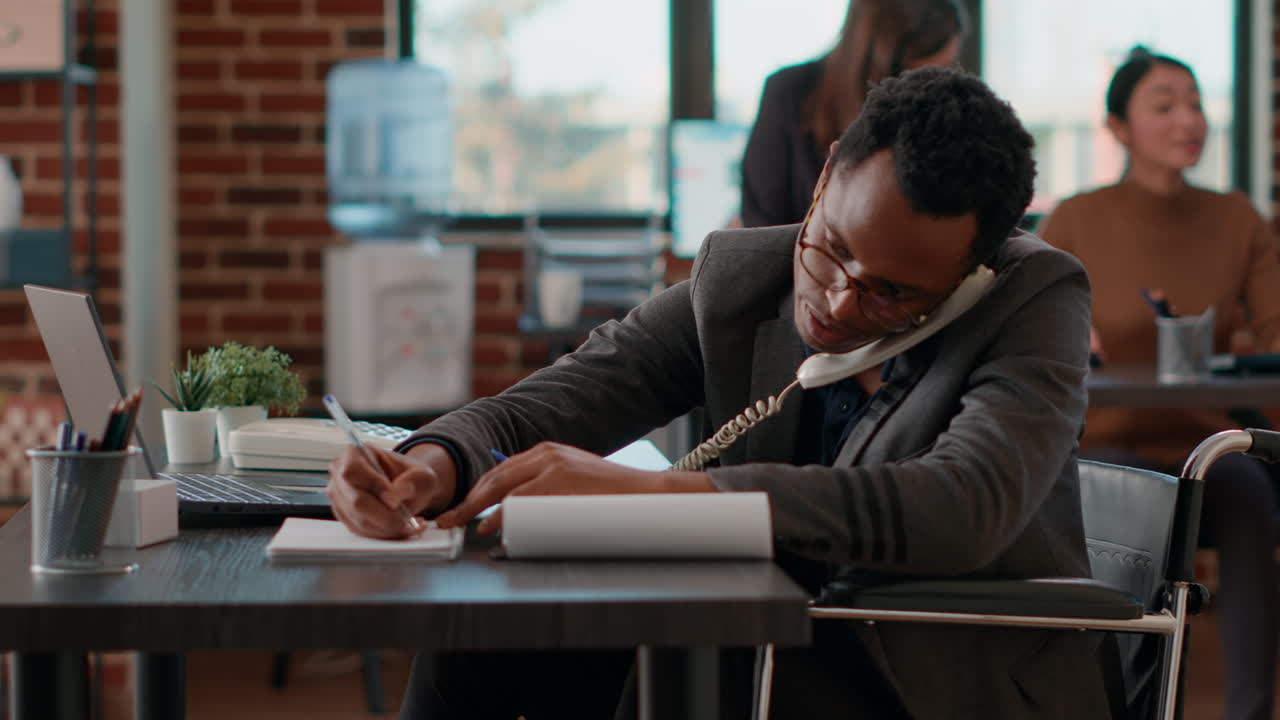 Company employee answering landline phone call in office