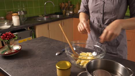 Close-up-shot-of-a-young-woman-crushing-butter-and-later-mixing-in-honey-from-a-jar