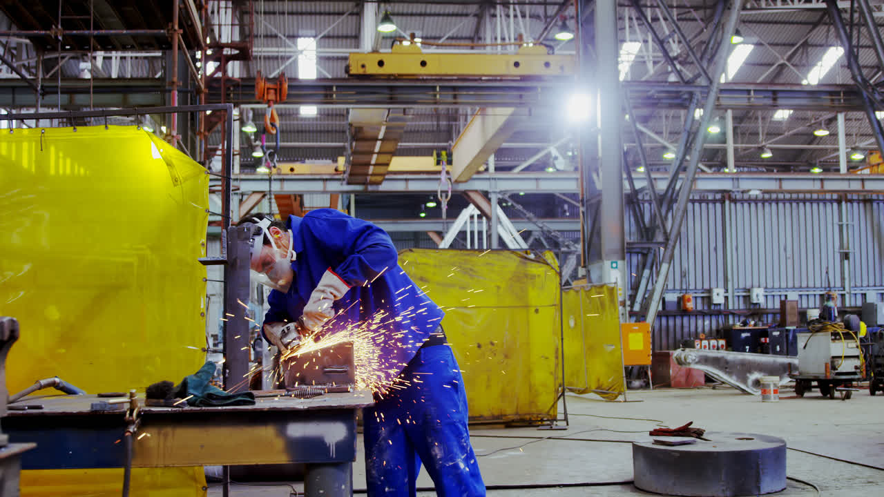 Male engineer using grinder machine 4k