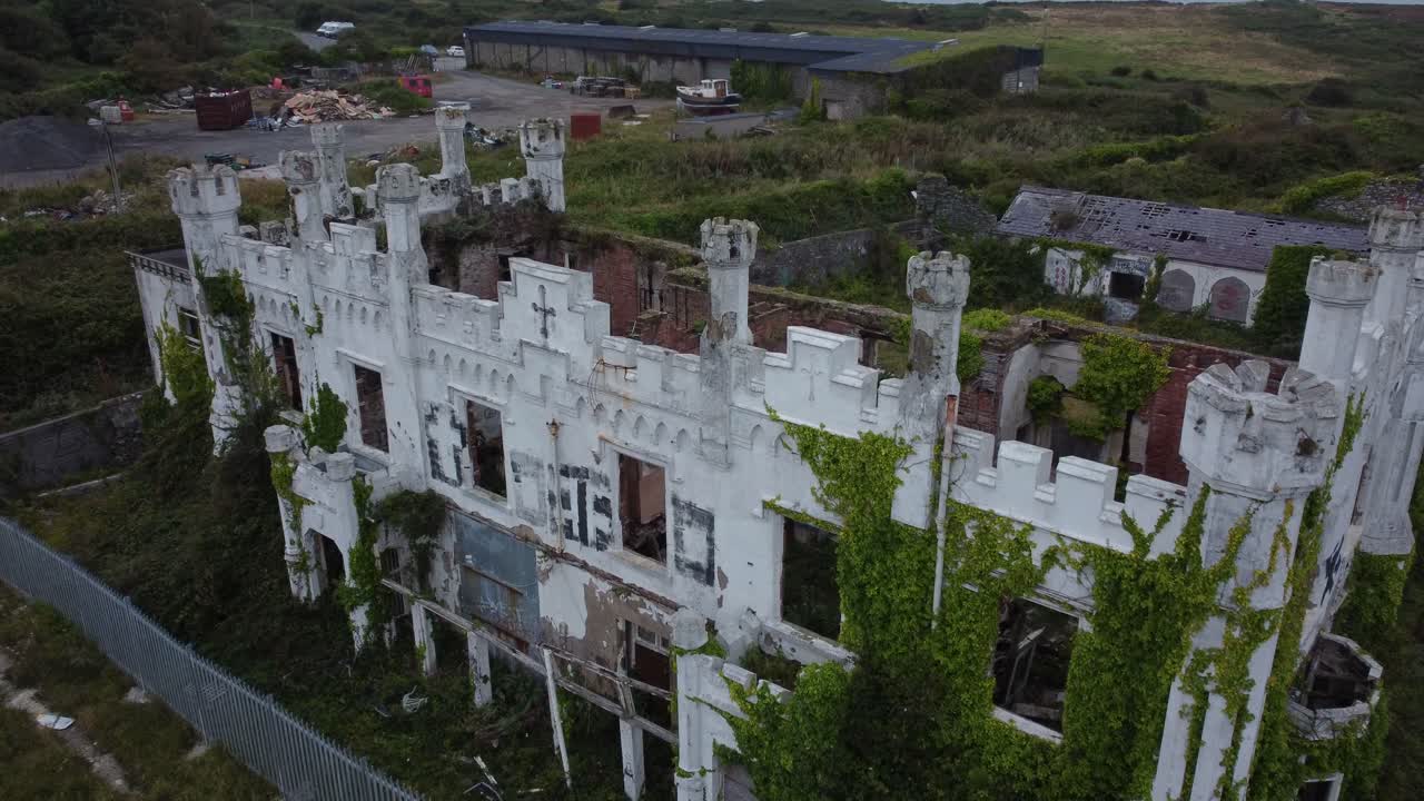 Soldiers point house aerial view rising over abandoned secured Holyhead Victorian castle mansion