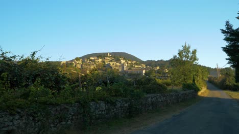 old typical provencal country village under sunny skies in slowmotion moving shot through nature