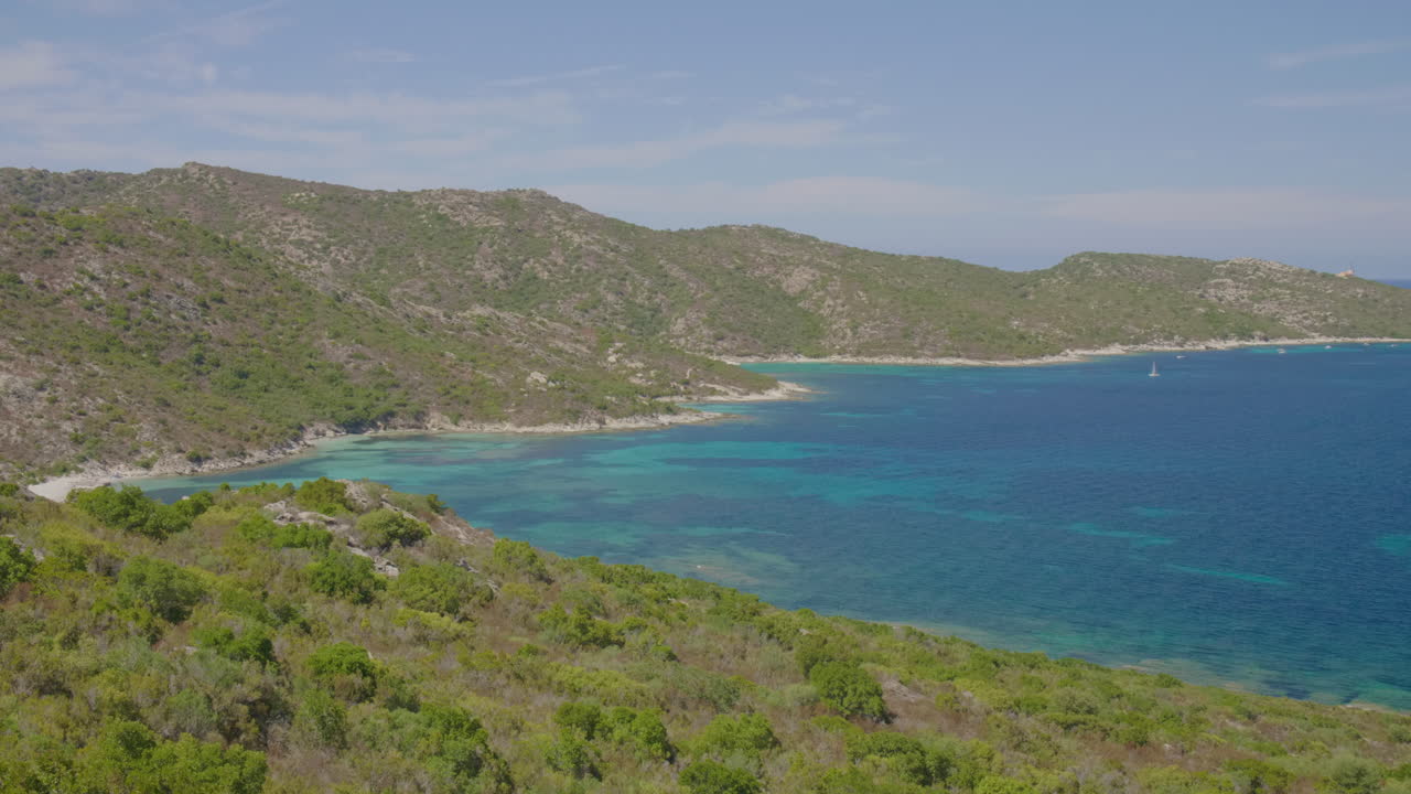 Saint-Florent Corsica panorama coast sunny view of crystal clear turquoise water, rocky shorelines under a bright blue sky serene Mediterranean landscape northern Corsican seaside