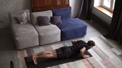 slow motion footage of a man doing push-up exercise at home