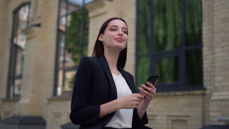 suit lady using mobile phone outdoor. businesswoman working smartphone on street