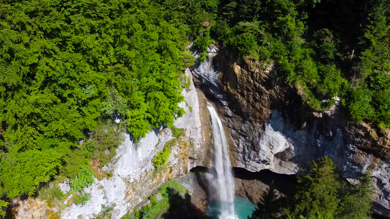 Aerial Reverse Shot Looking Down at Berglist&uuml;ber Waterfall in Swiss Alps