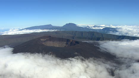 aerial establishing shot of the lareunion volcano crater surrounded by vast landscape