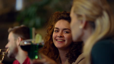 happy people drinking cocktails in bar. colleagues clinking glasses after work.