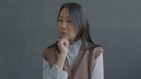 thoughtful asian woman