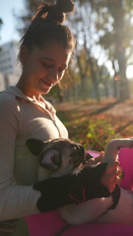 woman with her pug in a park