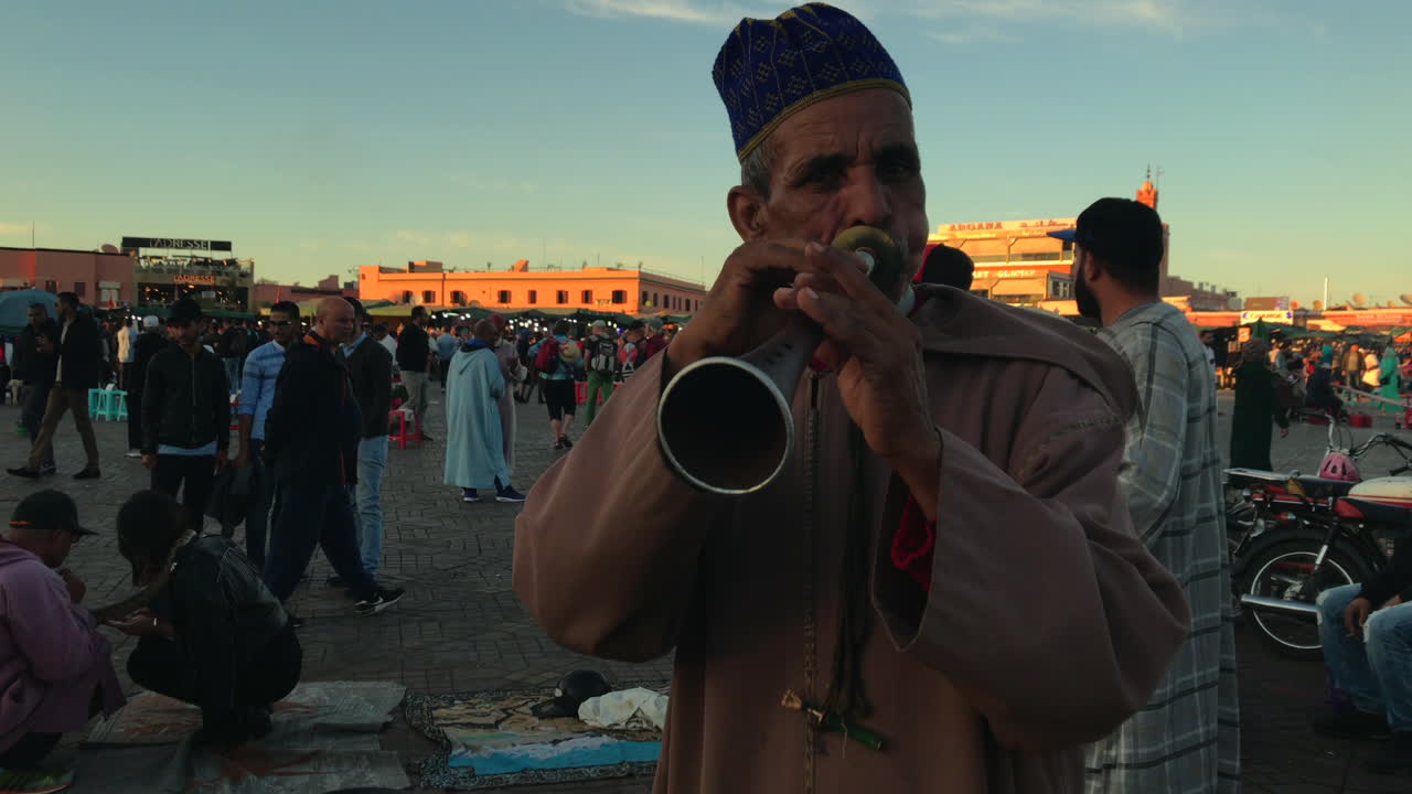Snake charmer plays flute on famous Djemaa el fna in Marrakech, Morocco