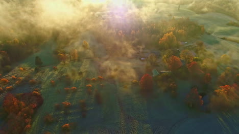 drone flyover above clouds, beautiful countryside landscape with autumnal colors, mystic morning light