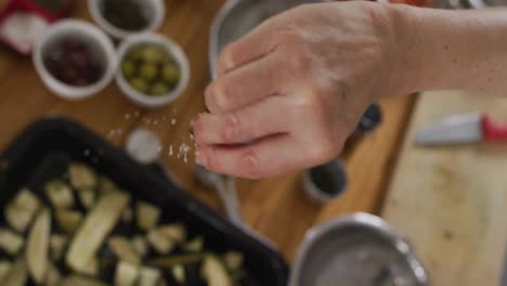 caucasian female chef teaching diverse group wearing face masks