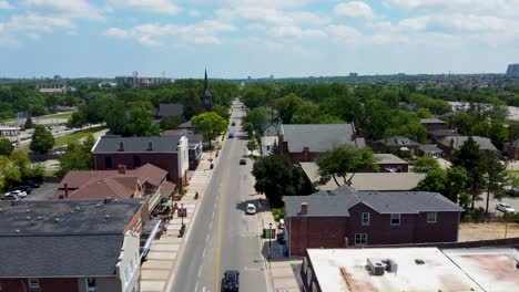 Drone-flying-over-small-downtown-shops-on-a-sunny-day-in-Mississauga