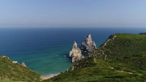 Aerial-View-of-Praia-da-Ursa-is-a-deserted-beach-located-in-Sintra,-Portugal