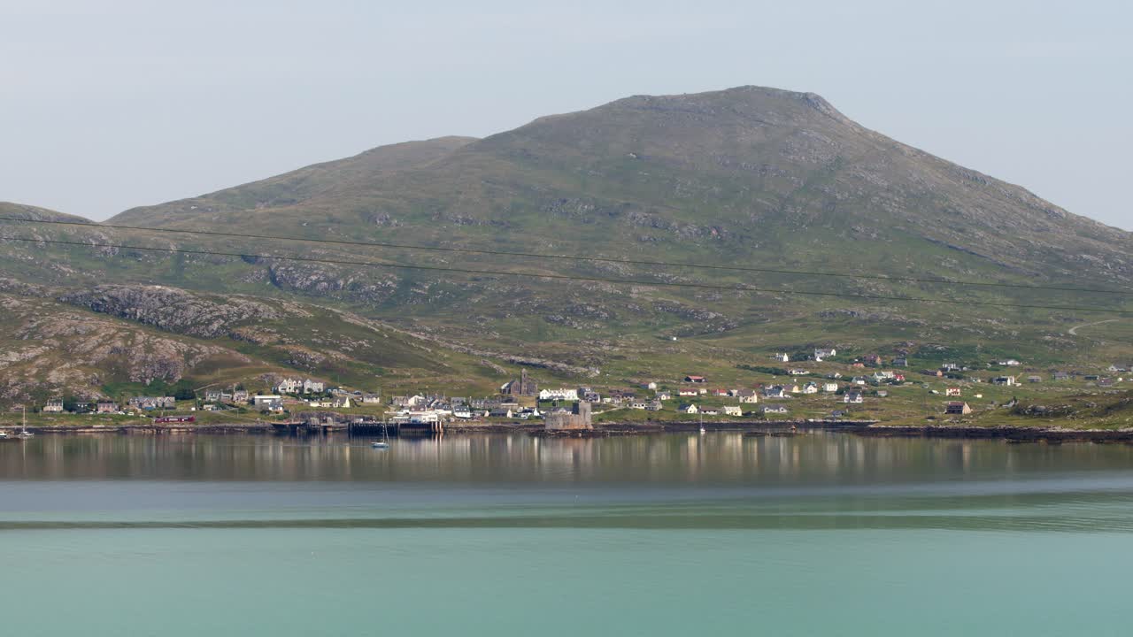 Shot of the light blue water around the village of Castlebay on a sunny day