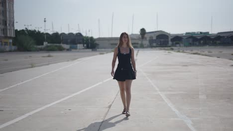 woman walking on an empty urban road